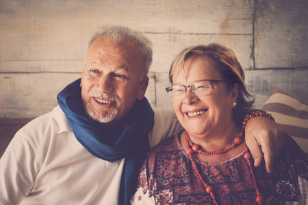 Two senior couple smiling happy at home. Vintage filter and fashion clothes for two beautiful elderly man and womanの写真素材