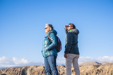 Senior mother and 45 year old son spend good time together hiking and observing the beauty that surrounds themの写真素材
