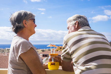 senior couple and man smiling under the sunの写真素材