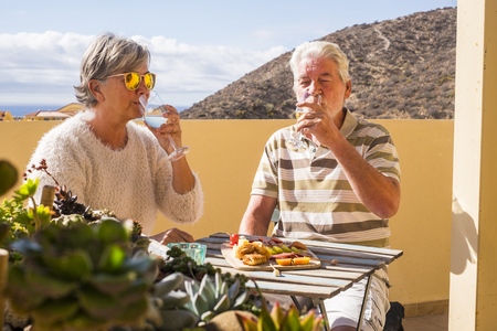 nice beautiful senior couple having a break on their terraceの写真素材