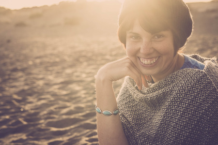 nice happy girl smile in the sunset time happy for vacation and leisure time outdoor. one person happiness travel concept with beach on the backgroundの写真素材