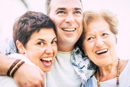 nice cheerful portrait of three caucasian people man and two woman and mother and son together in...