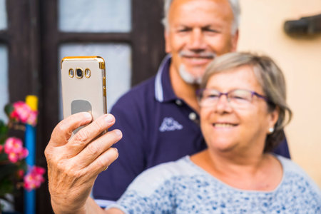 elderly couple man and woman using mobile phone