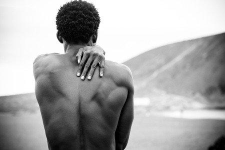 Protect and love conceptual image with black man african race viewed from behind with a man on his shoulder. clack and white fine art picture. nice body with muscles and lovely messageの写真素材