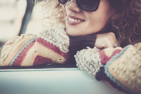 Cheerful woman middle age portrait in vintage colors filter - beauty and happiness close up caucasian model smiling and enjoying the outdoors while look on her sideの写真素材