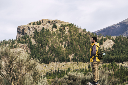 Man Traveler on mountain summit with clear sky around Travel Lifestyle success concept adventure survival vacations outdoor for people love outdoors parks and scenic places. Discover natureの写真素材