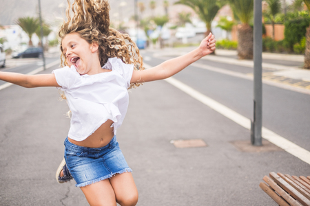 cheerful and happy young girl 8 years old smile and enjoy the day . smiles and happiness for the age of innocence and summer related holiday before the school back againの写真素材