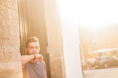 beautiful caucasian young boy looking at the camera directly and strong. nice expression for serious purpuoses. trendy and casual man with blue eyes. Vintage filter and retro colorsの写真素材