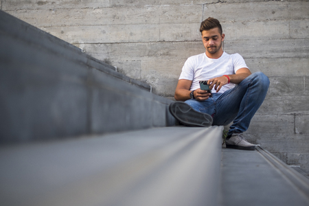 millennial generation next in deily leisure activity in the city using smartphone bored to connect and chat with friends alone too. internet people and social media diseaseの写真素材