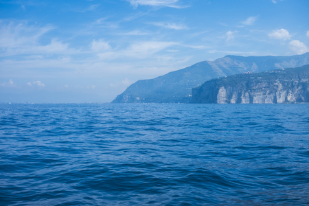 seaview from cruise boat of naples with vesuvio vulcan and campania cliff of italy in mediterranean water. wave and travel concept for tourist in summer vacation enjoying europeの写真素材