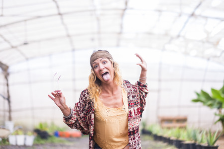 Crazy nice attractive middle age woman pose with rare funny expression - fashion hioppy clothes coloured fot happiness lifestyle peopleの写真素材