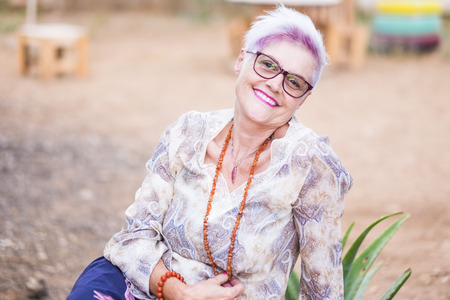 Youthful aged senior lady caucasian woman with pink and white hair smile at the camera - diversity and alternative concept for mature people like life with no limit age - beautiful retired womanの写真素材