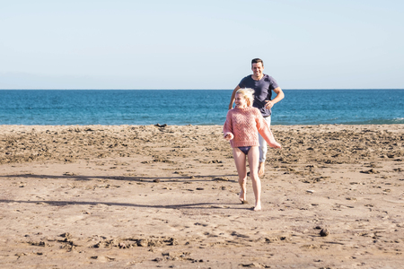 Happy cheerful people have fun and joy playing at the beach together in vaction - young people in summer time holiday on the coast enjoying love and relationship - nice lifestyleの写真素材