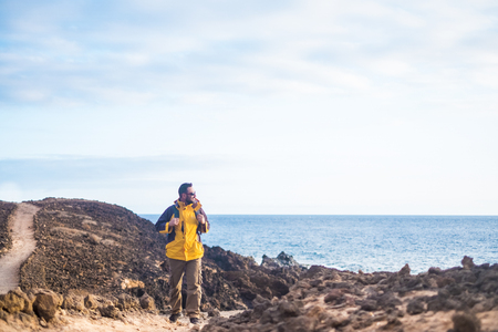 Caucasian man hiker doing trekking outdoor in clear sky day with backpack - travel and enjoy the outdoor leisure activity for people love freedom and lifestyle - alternative vacation for nice manの写真素材