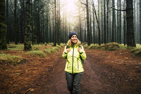 Happy people walking in the forest enjoying the pine treesの写真素材