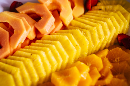Close up of fresh coloured exotic tropiacl fruits like pine and melon - seasonal natural food for healthy lifestyle and vegetarian peopleの写真素材