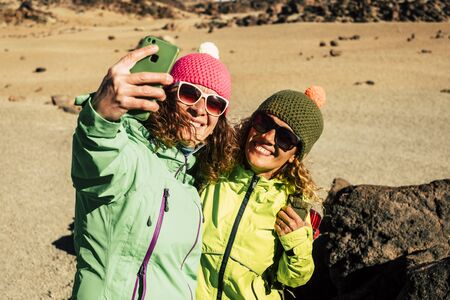 Healthy women enjoying the outdoor activity activity with a backpack and trekking equipment in the middle of the El Teide national parkの写真素材