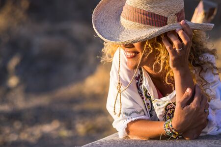 Smile for fashion trendy caucasian woman with cowboy hat in sunny outdoor leisure activity ejoying and relaxing - happy people concept with attractive blonde femaleの写真素材