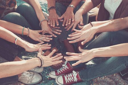 team and friendship concept with crowd of hands and feet all together touching and cooperate - caucasian people friends enjoying the outdoor leisure activity - hippy loveの写真素材