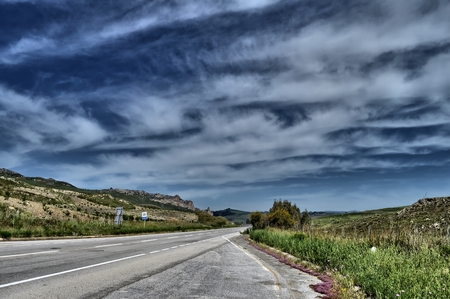 Asphalt Road Through a Rural Sicilian Landscape, Italy, Europeの写真素材