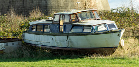 Old river boat abandoned in a fieldの写真素材