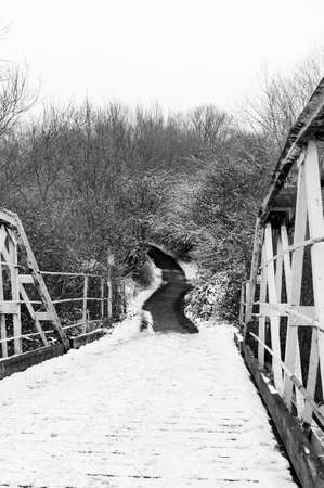 Snow covered footbridge on a winters dayの写真素材
