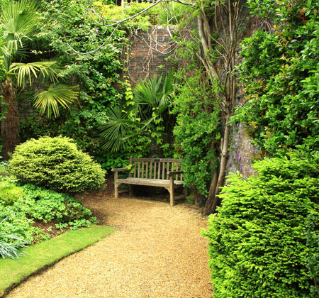 Gravel path and benches in a formal garden.の写真素材