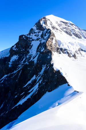 Moench mountain - View of the mountain Moench in the Bernese Alps in Switzerland - travel destination in Europeの写真素材