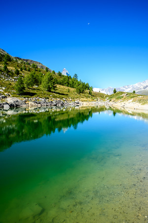 Gruensee (Green lake) with view to Matterhorn mountain - trekking in the mountains near Zermatt in Switzerlandの写真素材