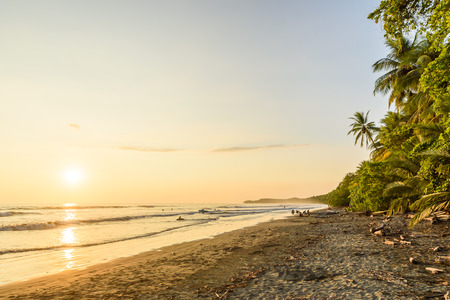Sunset at paradise beach in Uvita, Costa Rica - beautiful beaches and tropical forest at pacific coast of Costa Rica - travel destination in central americaの写真素材