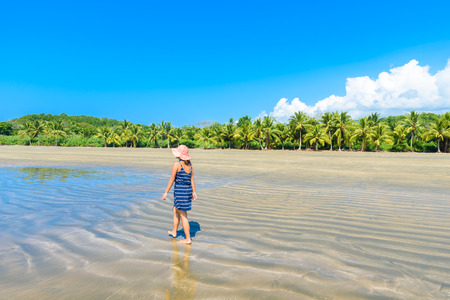 Girld walking in Marino Ballena National Park in Uvita - beautiful beaches and tropical forest at pacific coast of Costa Ricaの写真素材