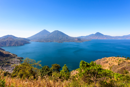 Panorama view of the lake Atitlan and volcanos  in the highlands of Guatemalaの写真素材