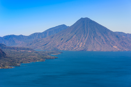 Panorama view of the lake Atitlan and volcanos  in the highlands of Guatemalaの写真素材
