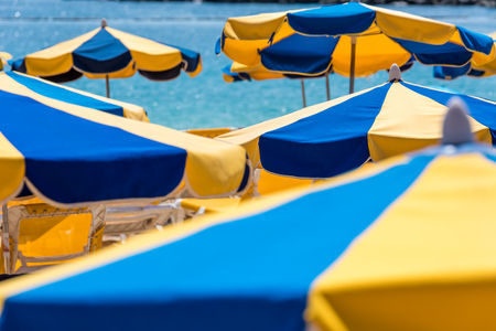 Sun umbrellas at sunny beachの写真素材