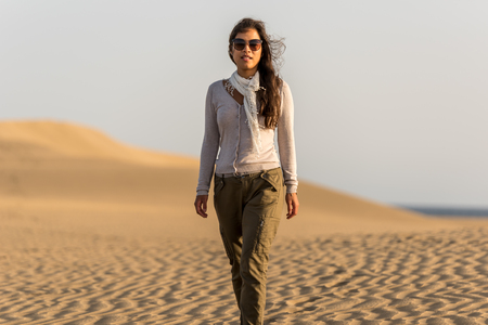 Girl walking on sand dunes in Gran Canaria, Spainの写真素材