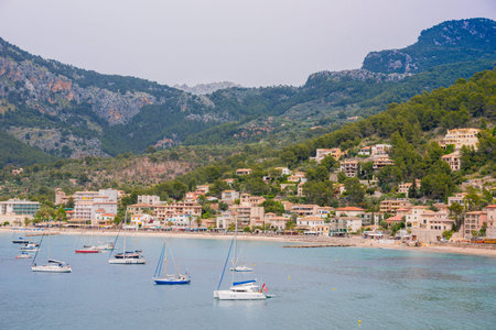 Puerto de Soller, Port of Mallorca island in balearic islands, Spain. Beautiful  beach and bay with boats in clear blue water of summer day.の写真素材