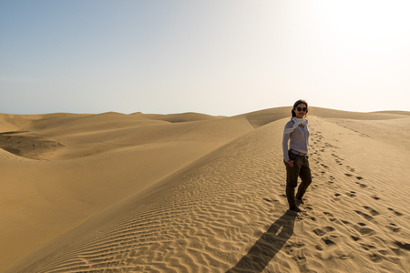 Girl walking on sand dunes in Gran Canaria, Spainの写真素材