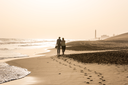 Couple walking together at beachの写真素材