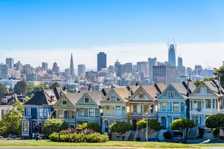 Beautiful view of Painted Ladies, colorful Victorian houses located near scenic Alamo Square in a row, on a summer day with blue sky, San Francisco, California, USAのeditorial素材