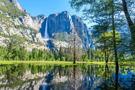 Yosemite National Park - Reflection in Merced River of Yosemite waterfalls and beautiful mountain landscape, California, USA