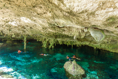 Cenote Dos Ojos in Quintana Roo, Mexico. People swimming and snorkeling in clear water. This cenote is located close to Tulum in Yucatan peninsula, Mexico.の写真素材
