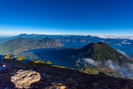 Panorama view of Lake Atitlan and volcano San Pedro and Toliman early in the morning from peak of volcano Atitlan, Guatemala. Hike on Vulcano Atitlan.の写真素材