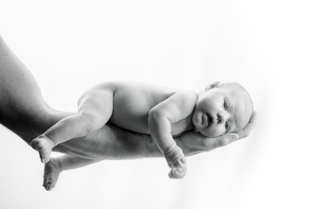 Newborn Baby in hands of dad -  happy family moments of parents with their children. Beautiful time in life.の写真素材