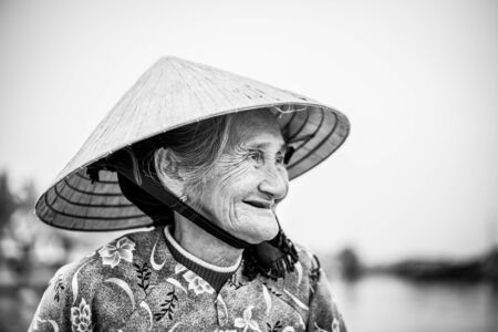 Old friendly woman with vietnamese straw hatのeditorial素材