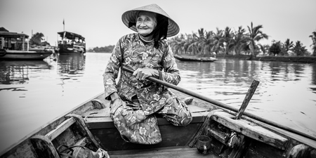 Old friendly woman with vietnamese straw hatのeditorial素材