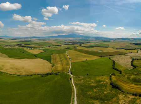 Gladiator Road with cypress trees in the Val d orcia (Orcia Valley) towards Terrapille - near Pienza in Tuscany, Italy - cypress trees along the famous white road, or strada bianca - Aerial viewの写真素材