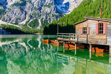 Wooden lake house at Lake Braies also known as Pragser Wildsee  in beautiful mountain scenery. Amazing Travel destination Lago di Braies in Dolomites, South Tyrol, Italy, Europe.の写真素材