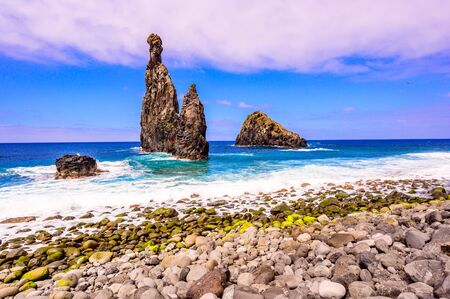 Lava islets in Ribeira da Janela at stony beach - Wild and beautiful coast with rock formations in the ocean near Porto Moniz on the island Madeira, Portugalの写真素材