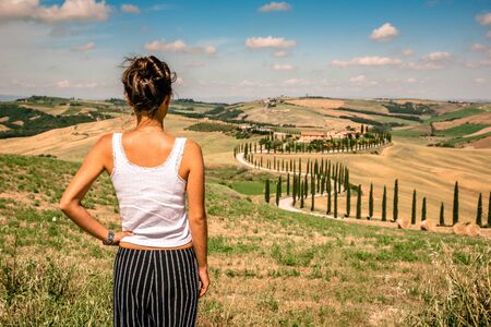 Beautiful landscape scenery of Tuscany in Italy - cypress trees along white road - aerial view -  close to Asciano, Tuscany, Italyの写真素材