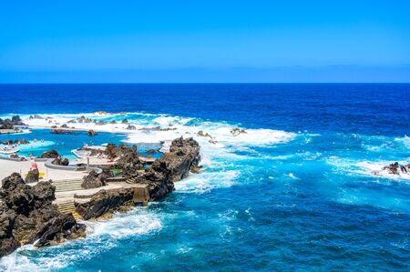 Natural volcanic swimming lagoon pools at Porto Moniz, travel destination for vacation, Madeira island, Portugalの写真素材